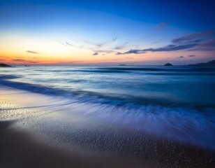 Fototapeta premium Golden sunset paints the sky over the ocean waves and sandy beach