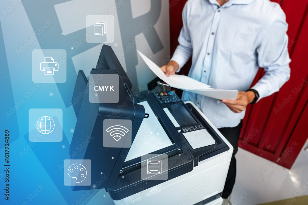 Poster man operating a modern printer while preparing documents in a creative workspace environment