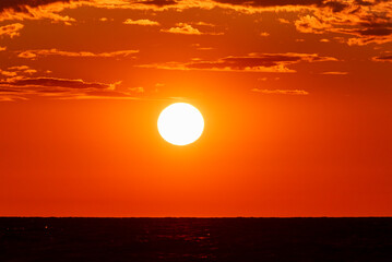 Beautiful sunset sky with orange and red hues over the calm Baltic Sea.