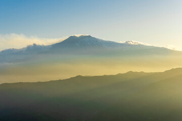 Obraz premium beautiful mountain sunset landcape with great magestic mountains and amazing slopes and canyons with evening clouds. Panorama of vulcano Etna in Sicily, Italy.