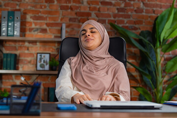 Relaxed Woman Sitting in Office Chair Near Desk Area