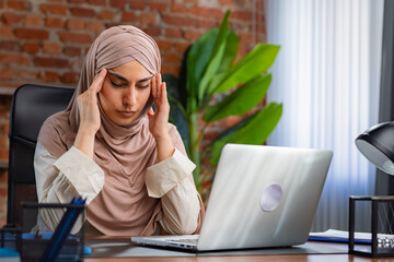 Stressed Woman in Hijab Working at Her Office Desk