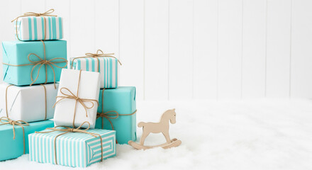 turquoise christmas gift boxes with wooden rocking horse on snow

