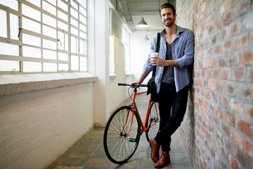 Portrait, bicycle and man in hallway, smile and coffee with commute, morning and confidence. Face,...