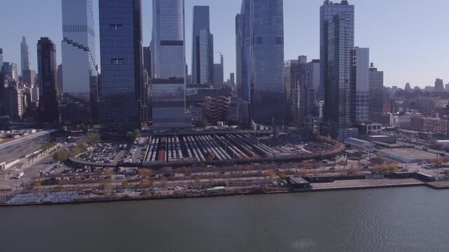 Drone close-up of the Hudson Yards rail yard with The Vessel and surrounding skyscrapers in New York City.