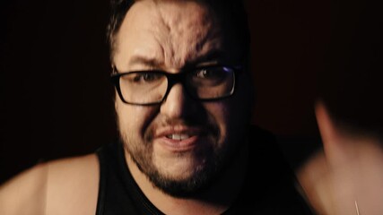 A grown man watches a TV show and swears. - Powered by Adobe