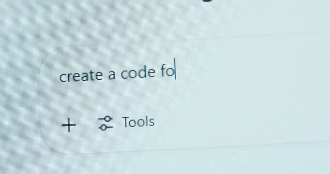 A user types &ldquo;create a code for&rdquo; into an AI chat interface, highlighting how artificial intelligence assists in programming and software development.