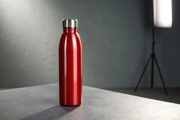 Red insulated water bottle on gray surface studio setting red bottle insulated bottle