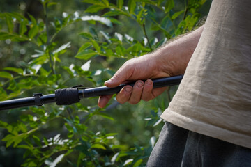A fisherman catching fish. Fisherman's hands with a fishing rod in his hands close-up.