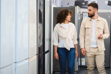 Couple choosing home appliances in electronics store