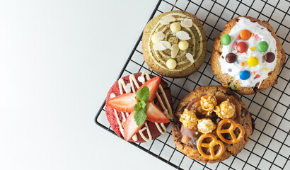 Assortment of fresh chocolate American chip cookies with salted camel, caramel popcorn, matcha tea...