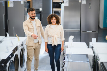 Couple exploring home appliances in electronics store