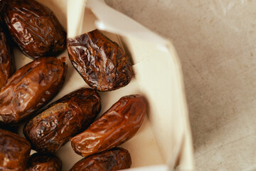 Dried dates on sale at outdoor farmer market. The fruit shrinks during this process, leaving a small, energy-dense dried fruit. Organic produce. Close up. Part of the series