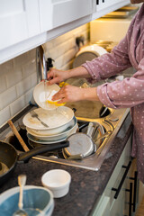 Female hands washing dishes in kitchen, the mindful chore