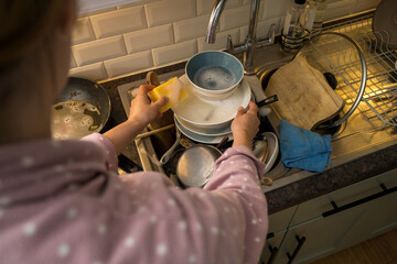 Female hands washing dishes in kitchen, clean space - clean mind