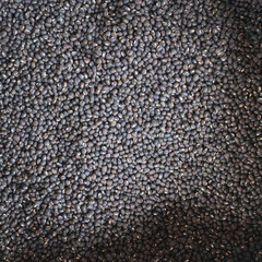 This image presents black bean seeds in a substantial sack, showcasing their journey from raw...