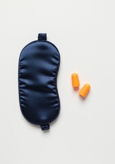 Sleep Accessories: Silk Eye Mask and Earplugs on White Background