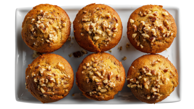 A delicious plate of nut-topped muffins, perfect for breakfast or snacks, isolated on white background.