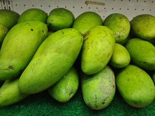 Stack of fresh mangoes on display