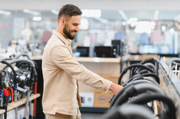 Customer choosing vacuum cleaner in electronics store