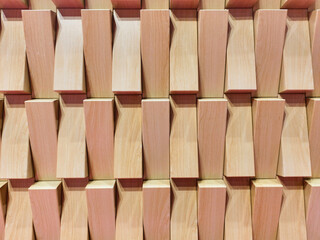 Geometric wood paneling. Modern light wood texture. Angled blocks creating depth. Abstract wooden background. Interior design element.