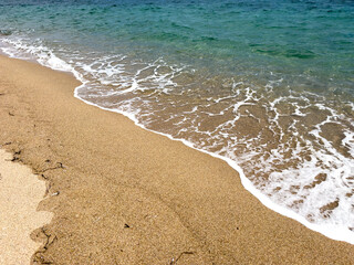 waves and sand with turquoise water on the beach