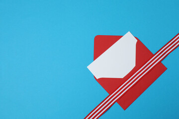 red envelope with ribbon on blue background
