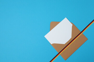 Kraft envelope with ribbon on blue background
