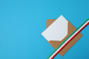 Kraft envelope with ribbon on blue background
