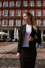 Businesswoman walking in plaza mayor, madrid, spain