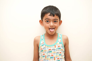 tongue out kid-a cute indian asian boy of 5 years with gorgeous eyes and facial expression