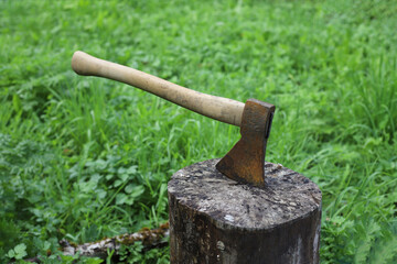 chop wood. the axe lies on a wooden block in the yard