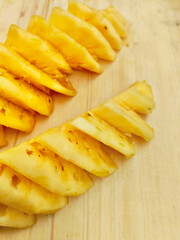 Bright Yellow Pineapple Chunks on a Cutting Board