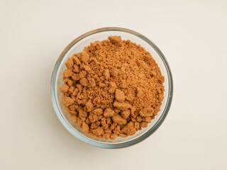 Biscuits crumble in a glass bowl on white background