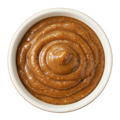 Fototapeta premium A close-up view of a bowl of creamy brown sauce with a smooth, spiral texture, set against a plain background