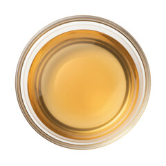 A top-down view of a clear glass filled with golden liquid, set against a plain background