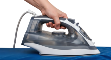 hand holds modern steam iron pressing clothes on an ironing board