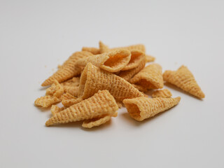 Crunchy snacks piled on white background