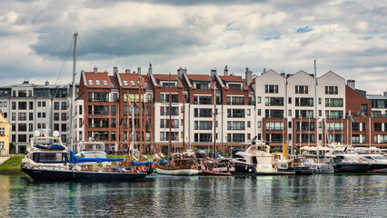 Yachts and sailboats at the Gdańsk Marina on the Motława River in Poland. Concept of luxury lifestyle, travel and waterfront real estate.