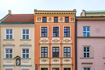 Colorful facades of historic buildings in the Old Town of Kraków, Poland. Concept of european architecture, travel background and urban patterns.
