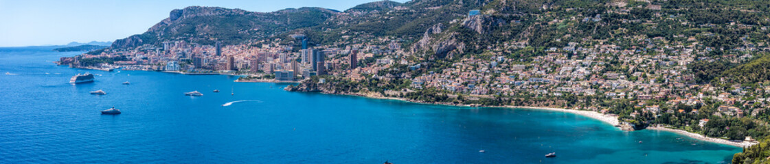Fototapeta premium wide angel aerial landscape view of Mediterranean coastline of Monaco and Roquebrune-Cap-Martin, located on French Riviera with skyline and skyscraper as well yachts and cruise ships in the bay