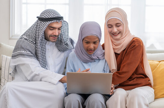 portrait bonding muslim couple help teenager girl learning on laptop computer in a cozy room - Powered by Adobe