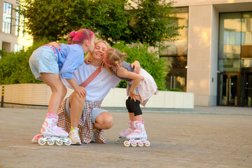 Joyful outdoor family moment: mother and her two daughters embrace in a group hug during sunset in a city park