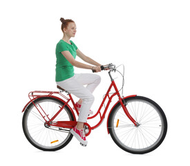 Teenage girl riding bicycle on white background