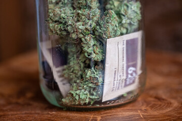 Glass jar with homegrown dried cannabis marijuana buds and humidity control packs