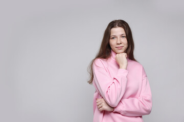 Fototapeta premium Portrait of teenage girl on light grey background, space for text