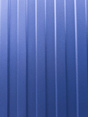 Close-up of a blue corrugated metal surface with vertical lines and subtle texture. Industrial and modern background ideal for architecture, construction, design, and abstract concept themes.
