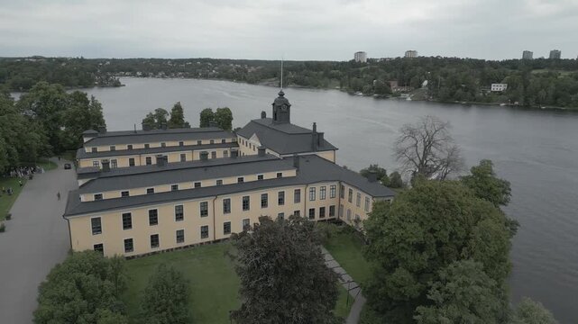 Aerial view of the Confidencen Ulriksdal theatre surrounded by lush greenery, bordering the tranquil waters, Solna, Stockholm County, Sweden.