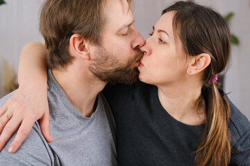 Mature couple hugging hugging each other kissing at home bedroom. Intimate Moment. Tender embrace...