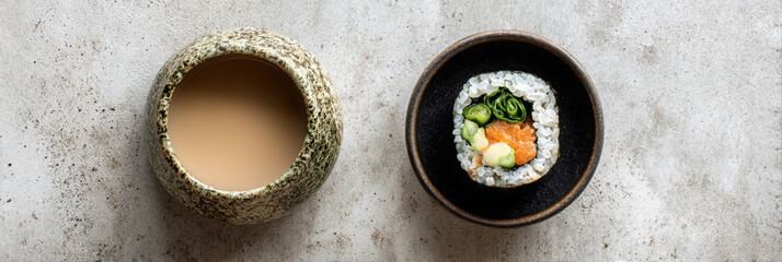 Sushi, roll, and miso soup presented beautifully with appetizing appearance